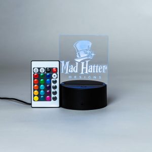 square light up sign with Mad Hatter logo engraved on it with remote to change colors